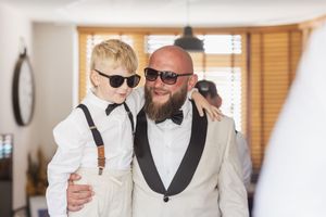 Stylish pair in formal attire share a special moment indoors.