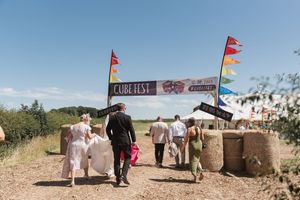 Desert themed wedding setup with flags and decorative bales in arid landscape.