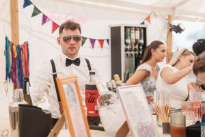Wedding celebration indoors with colorful bunting decorations and festive atmosphere.