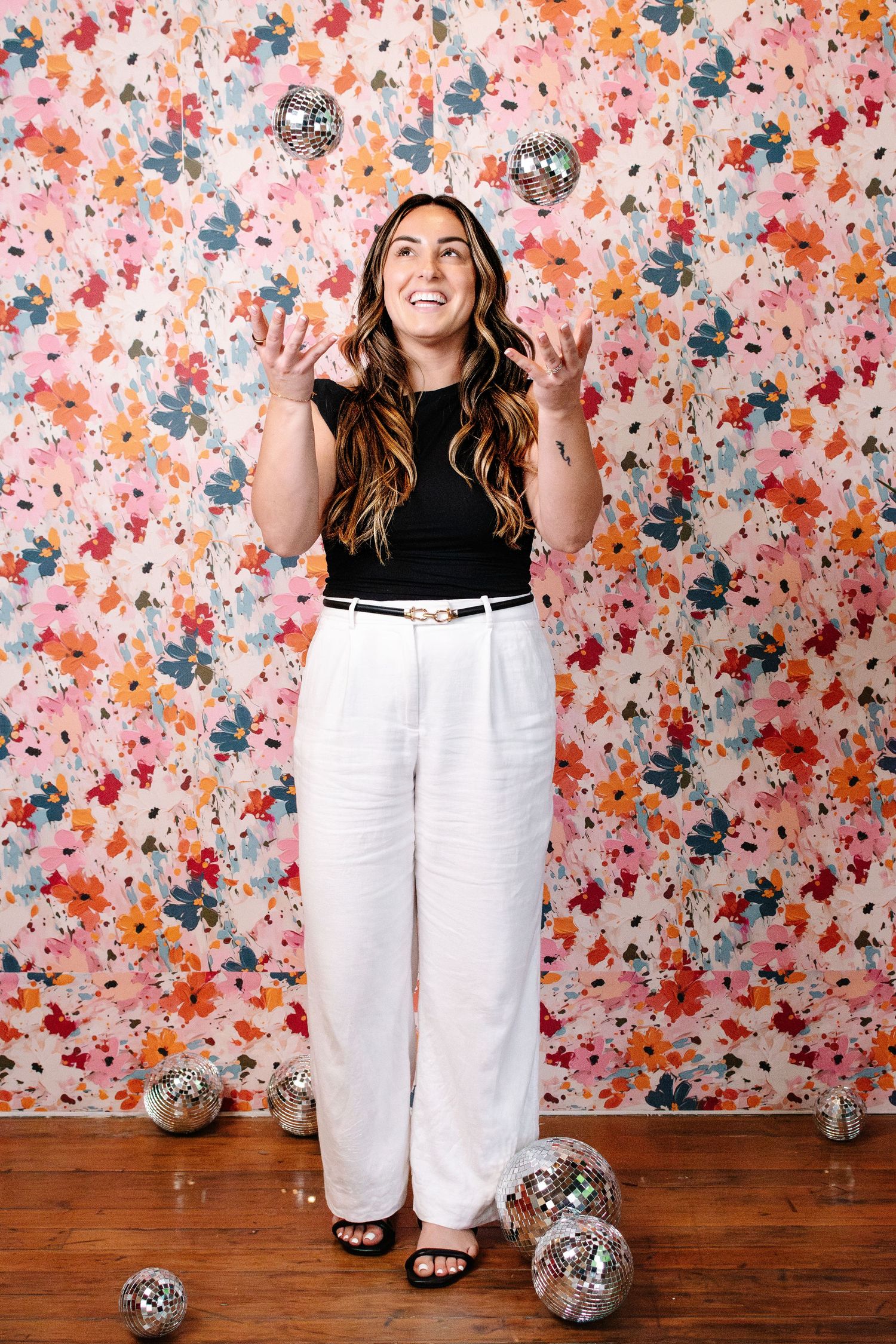 Photographer Natalie tossing disco balls during Seattle branding photo session