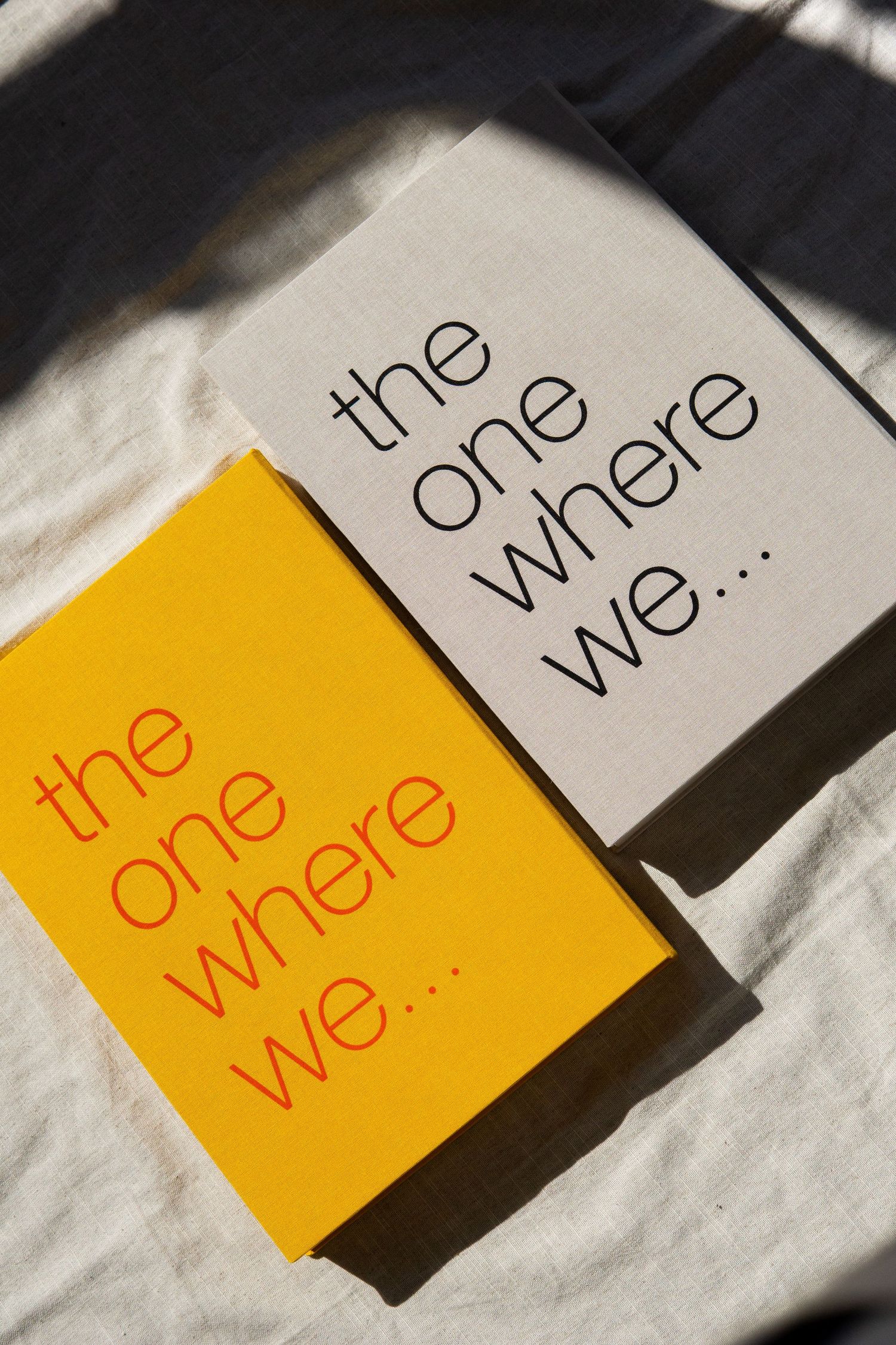 Yellow index cards with black text cast strong shadows on a white surface in a minimalist composition.