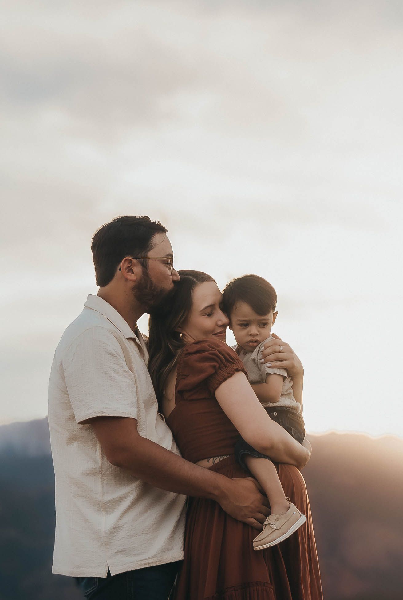 A family shares tender embraces and affectionate moments against a sunset backdrop in a series of intimate photos.