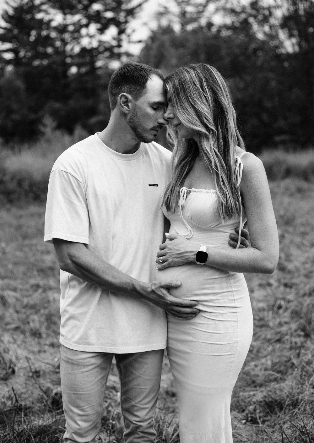 pregnant couple in black and white
