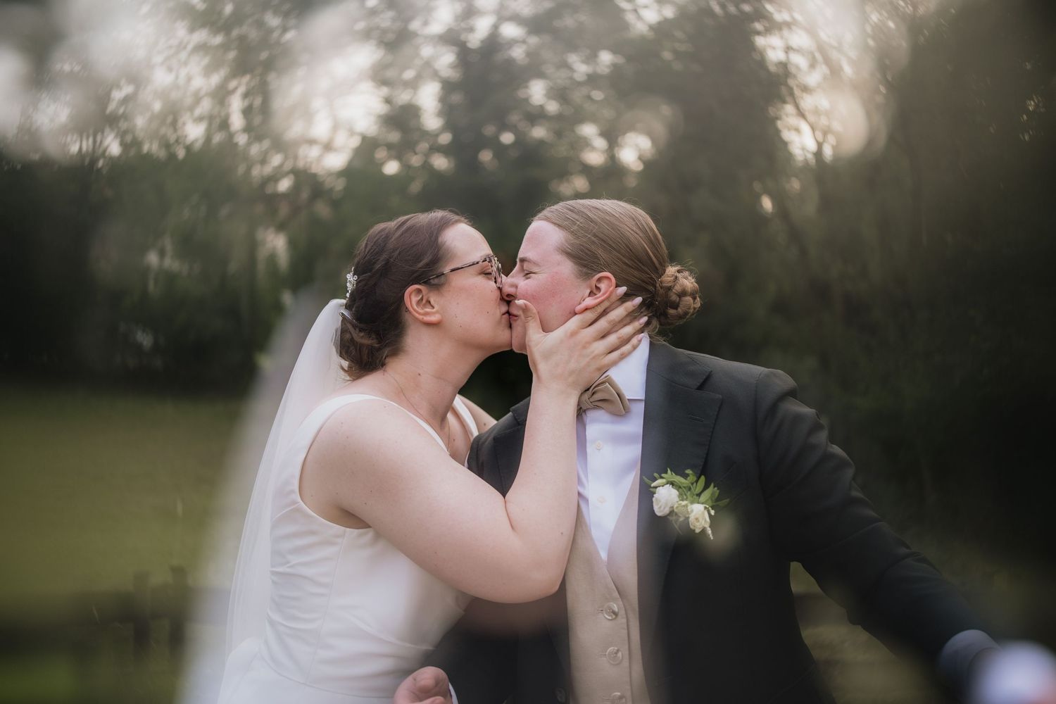 Romantic wedding moment captured in a dreamy garden setting at dusk.