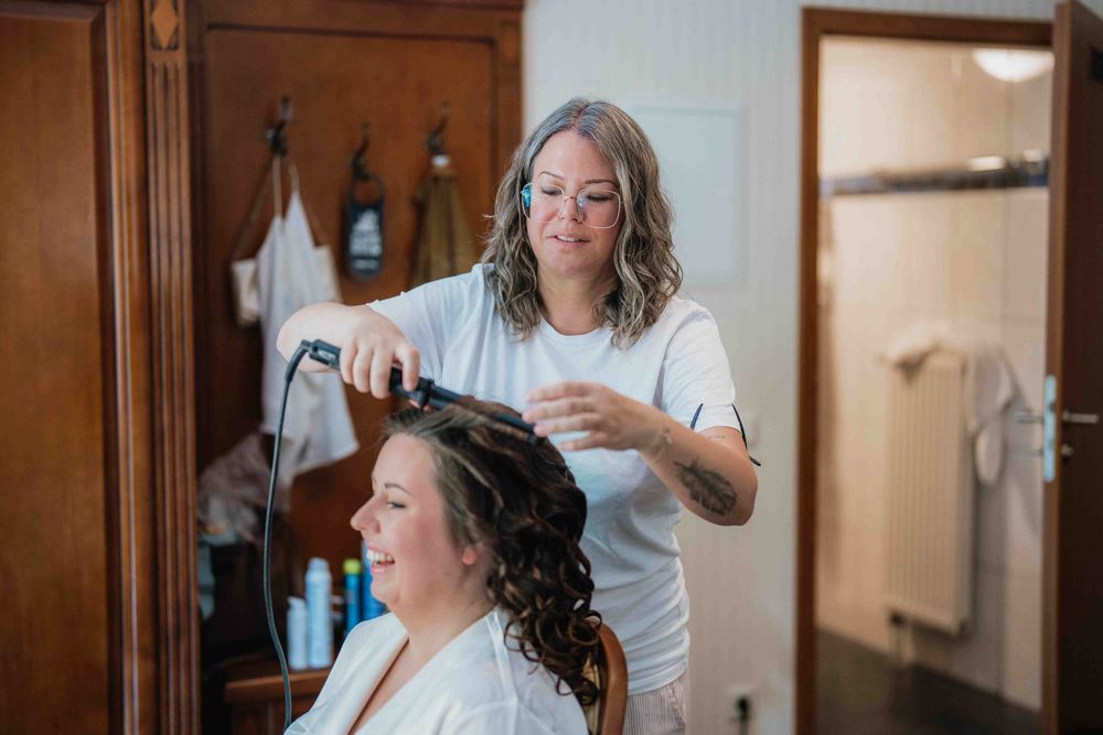 A hairstyling session in progress at a beauty salon.