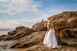 Wedding photography series on rocky coastal cliffs with ocean backdrop.