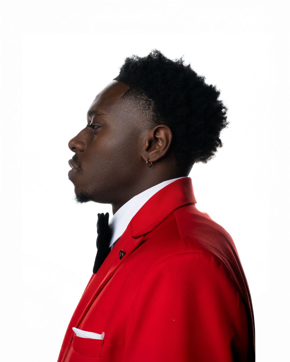 Profile view sequence of person wearing bright red formal suit jacket.