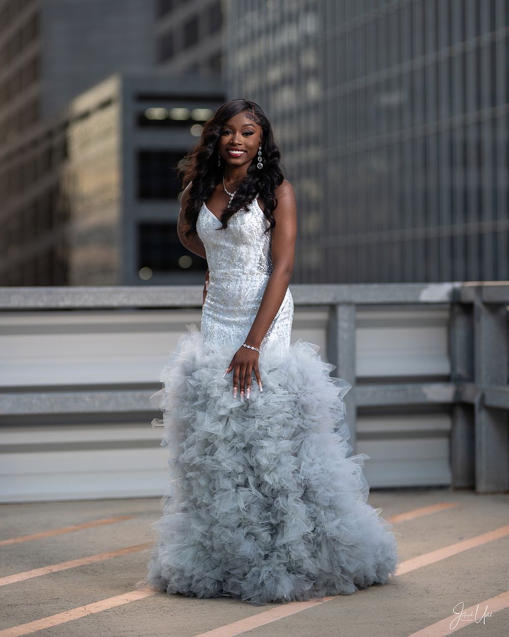 Elegant gray tulle gown photographed against urban architecture.
