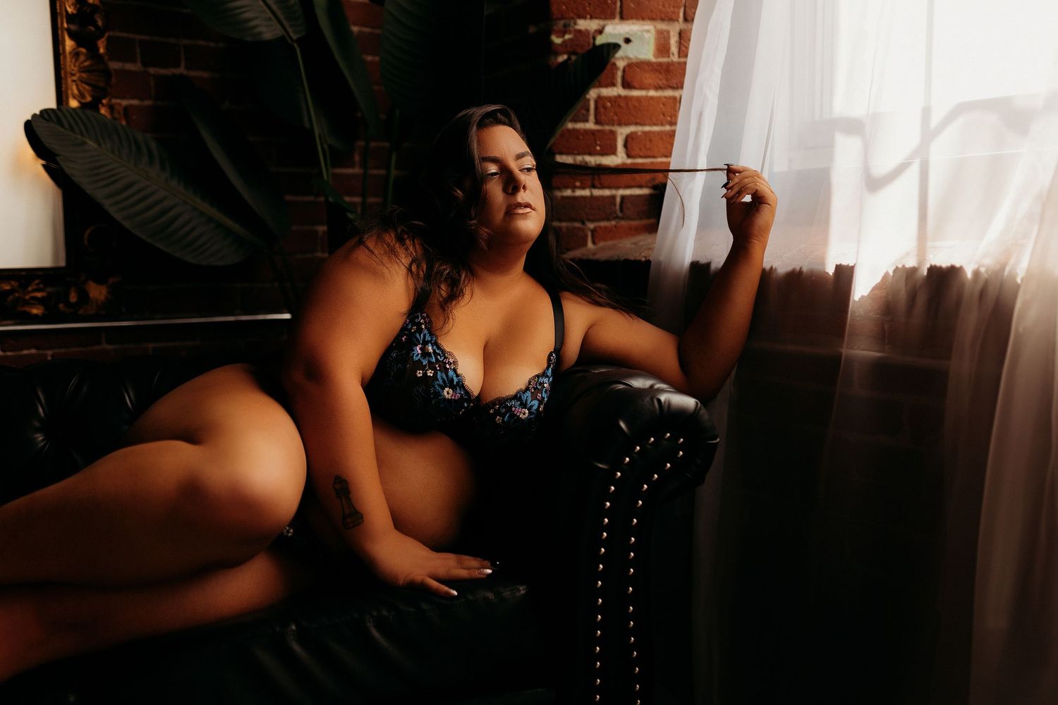 Boudoir photo series showing silhouetted figure in intimate poses against brick wall with dark lighting.