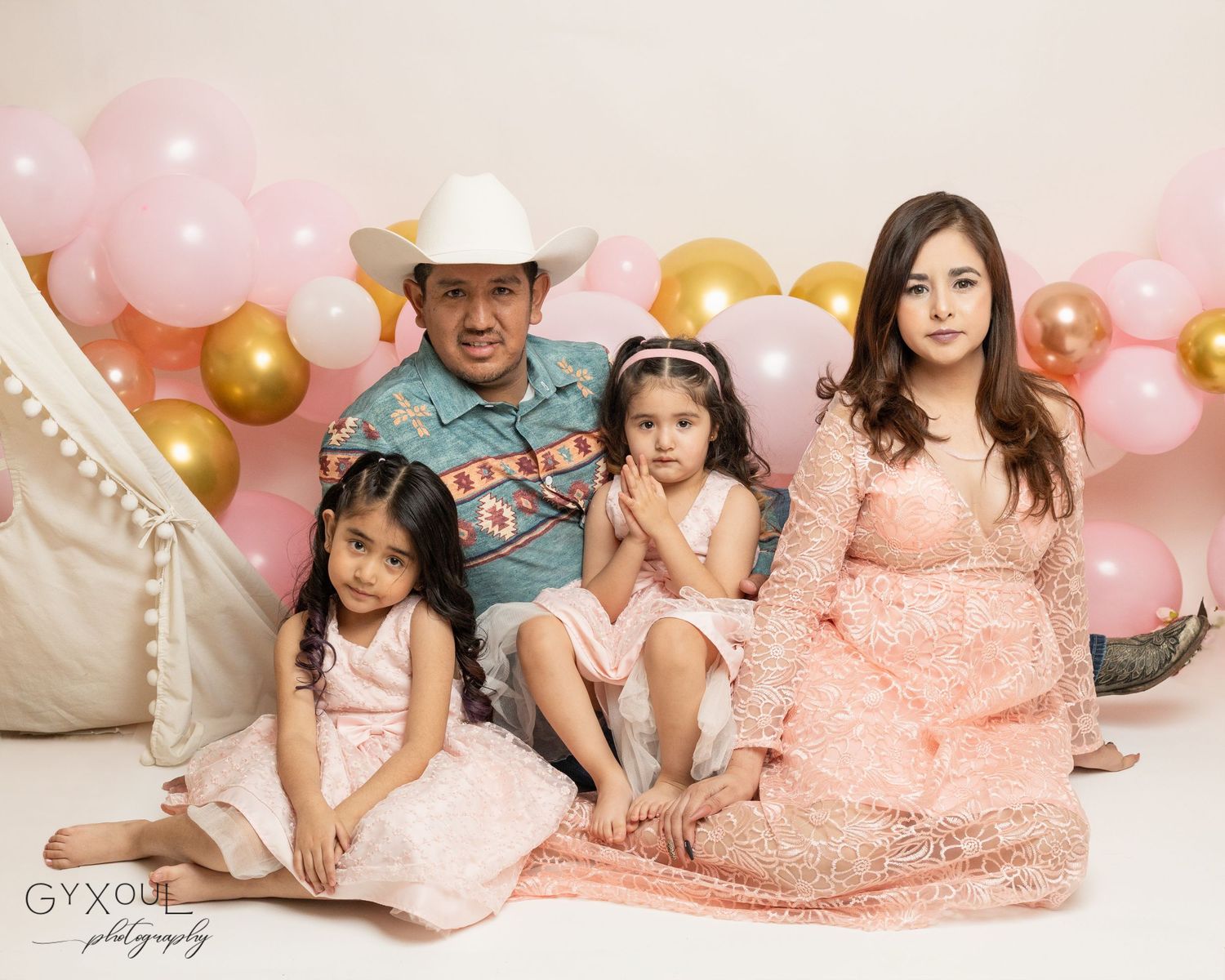 Professional blush pink and gold cake smash portrait photography setup with balloons and decorative accents.
