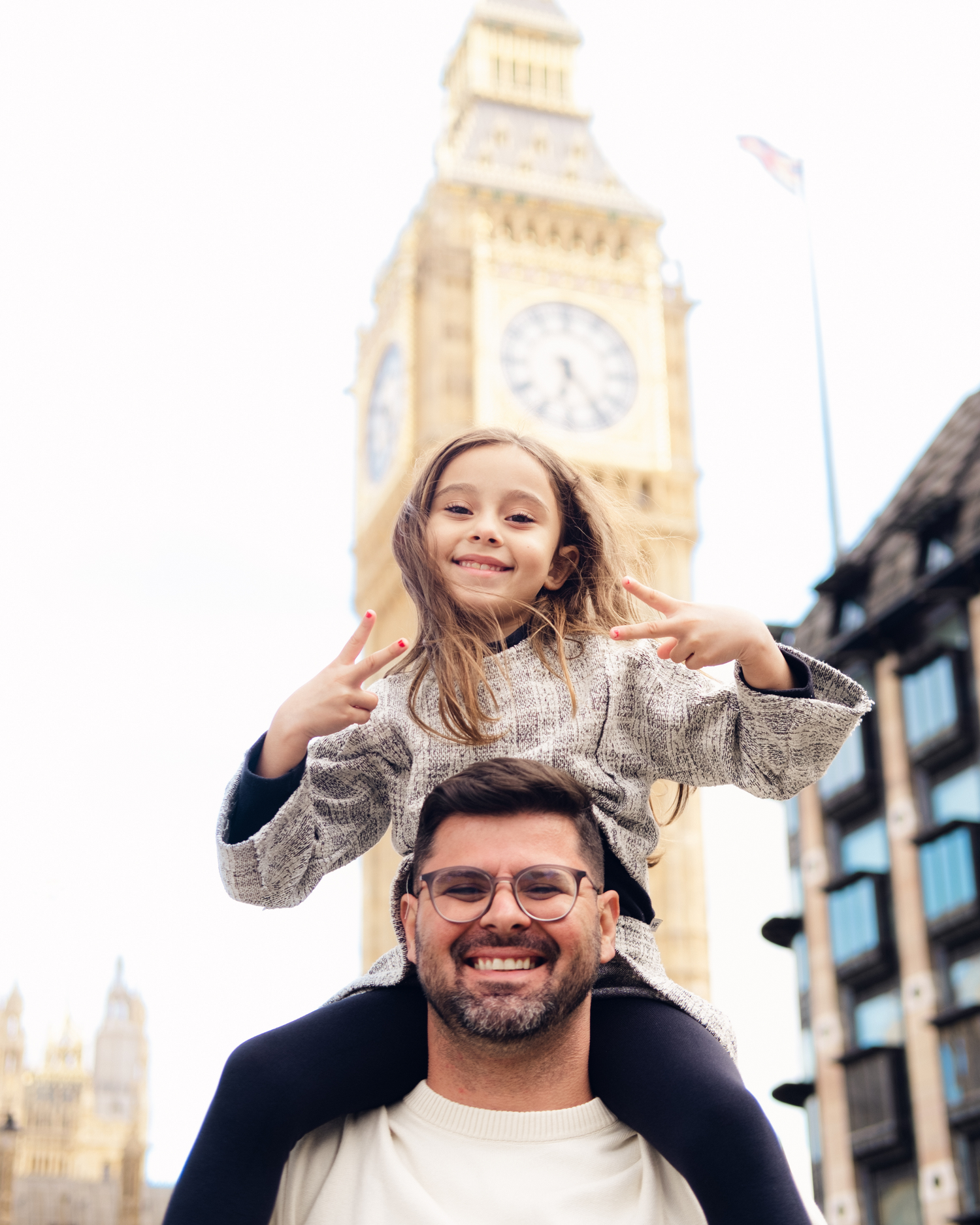Joyful moment captured in front of London's Big Ben with iconic clock tower in background.