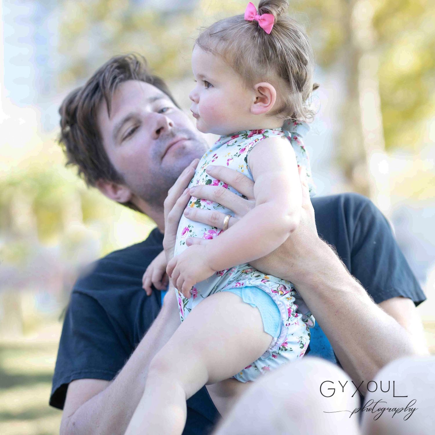 Sweet moment between parent and child playing outdoors on sunny day.