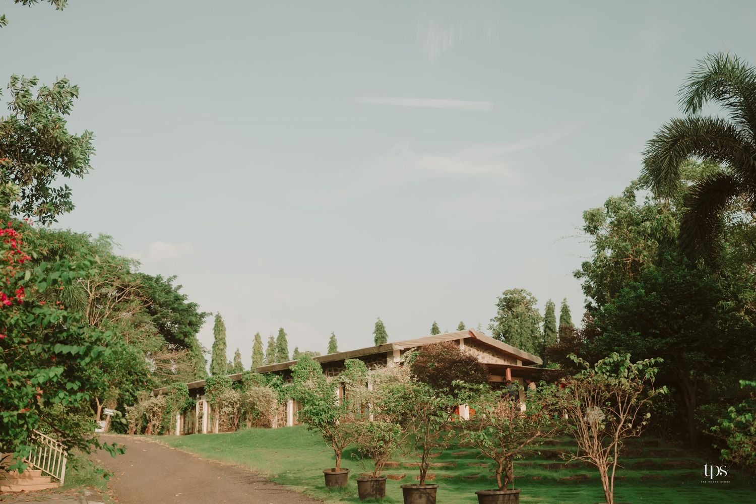 A rustic stone building nestled among trees and greenery in a tranquil countryside setting.