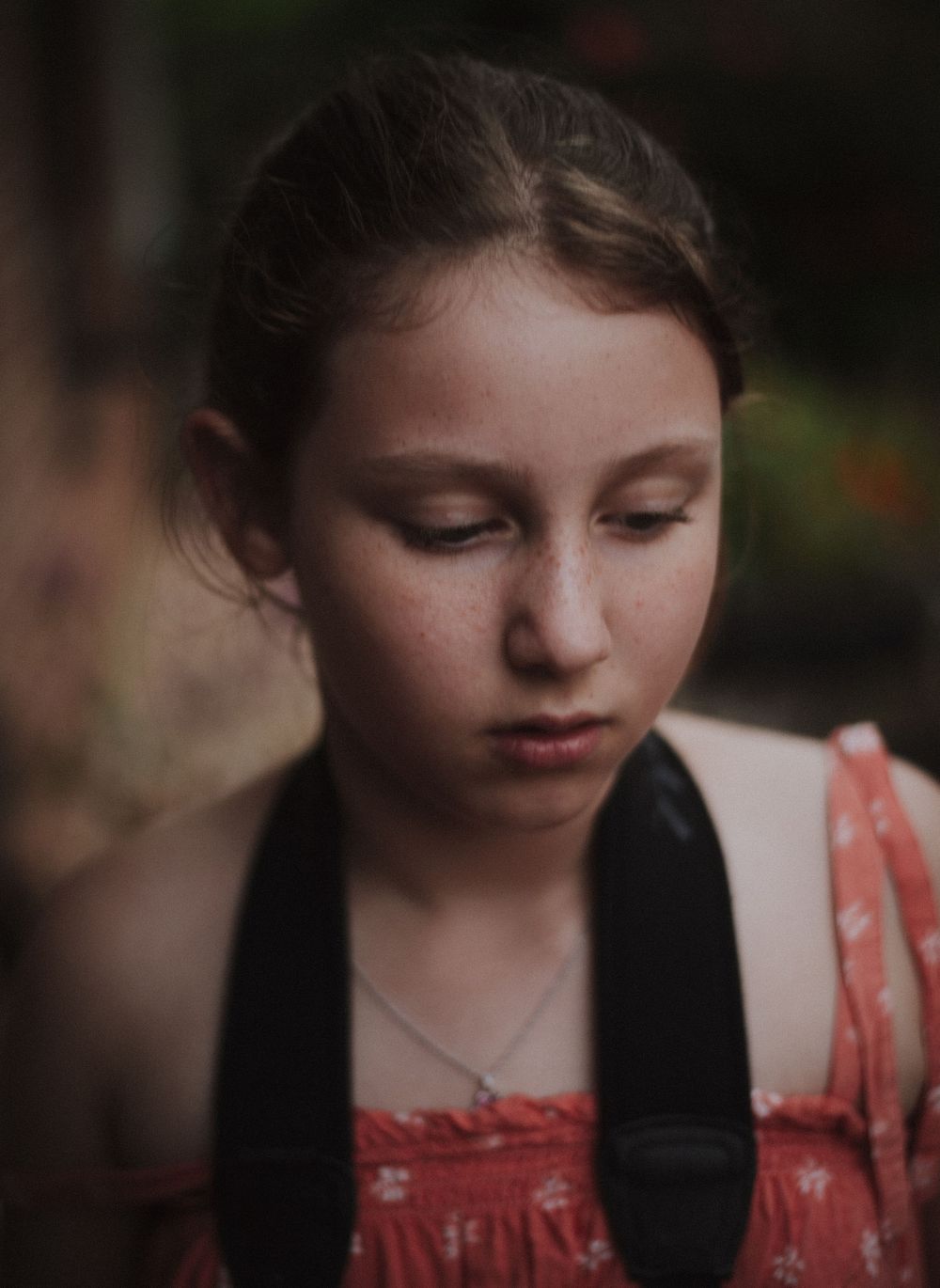 Moody portrait series featuring red dress and dark background.