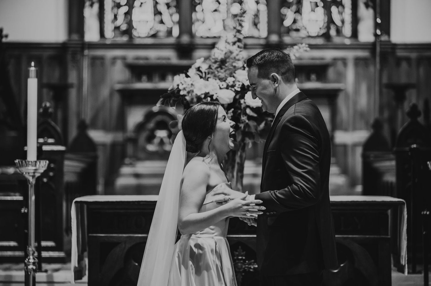 A black and white photo of the bride and grooms first kiss