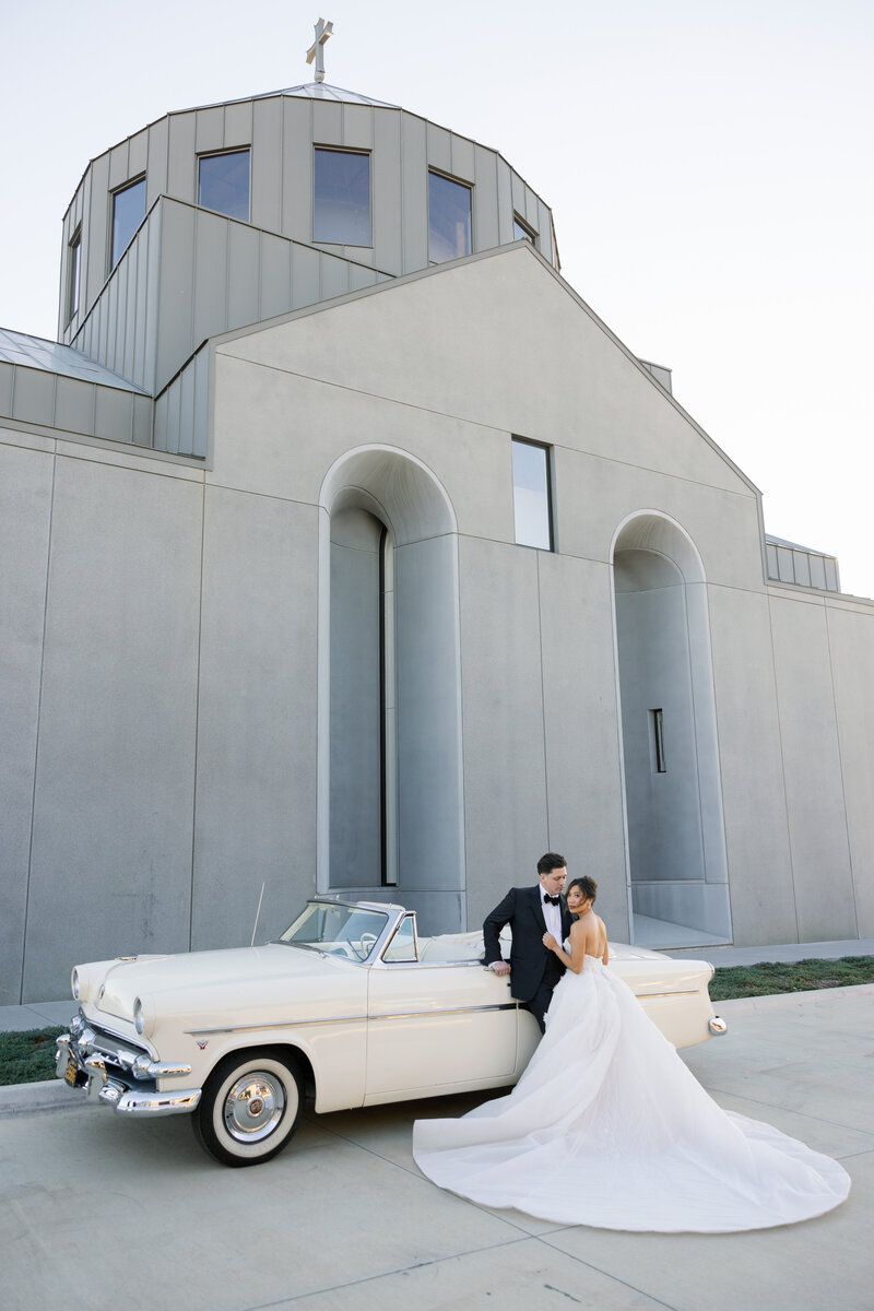 Bride and groom with a vintage car outside at The Hall of Lights, a Dallas wedding venue
