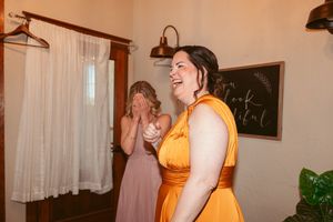 Bridesmaids sharing joyful laughter during wedding preparations.