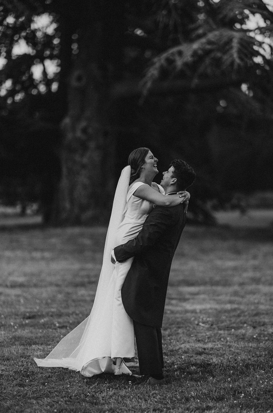 Black and white photo sequence shows bride and groom gracefully swaying together in a park setting over four frames.
