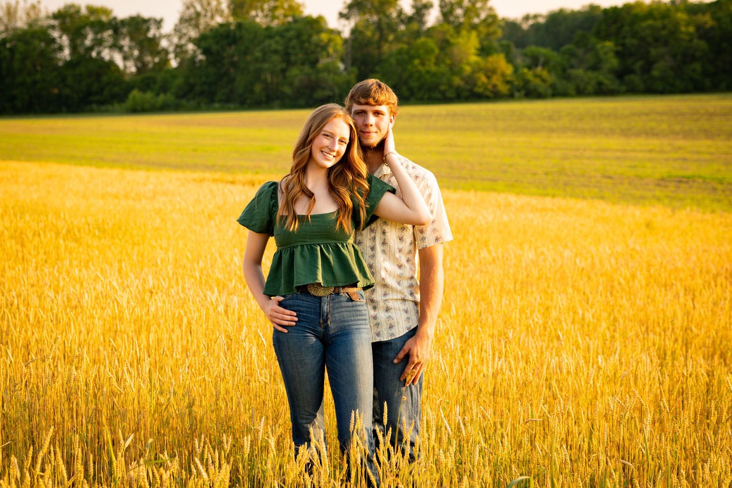 Two people walking together through a golden wheat field at sunset while capturing multiple moments in their journey.