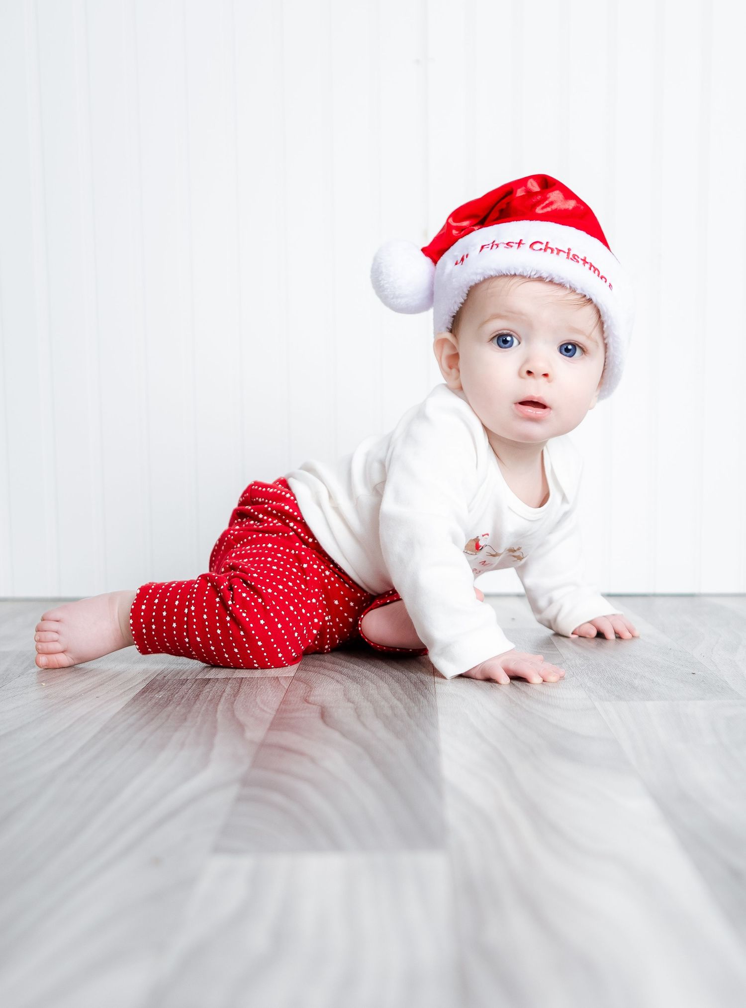 Infant milestone photography featuring a baby in a Santa hat for a holiday session in Lincoln, Alabama