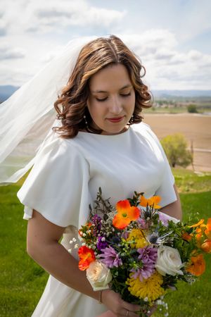 bride looking at bouquet