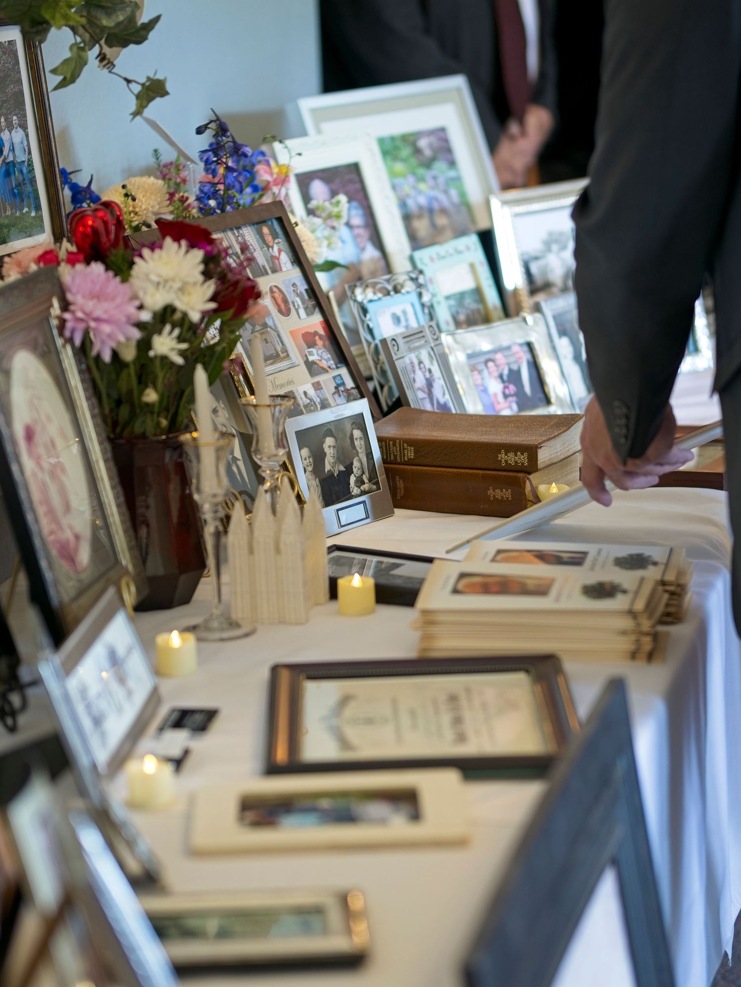 A table filled with pictures and mementos at a funeral