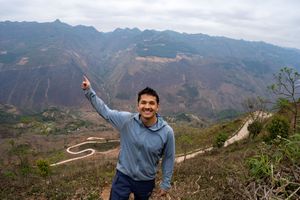 Scenic mountain vista showing winding roads and terraced hillsides in Northern Vietnam.
