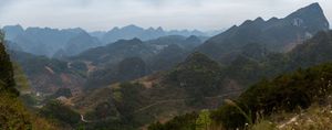 Sweeping panorama of jagged mountain peaks stretching across the horizon.