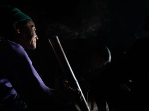 Silhouetted figures in darkness with subtle purple lighting effects.