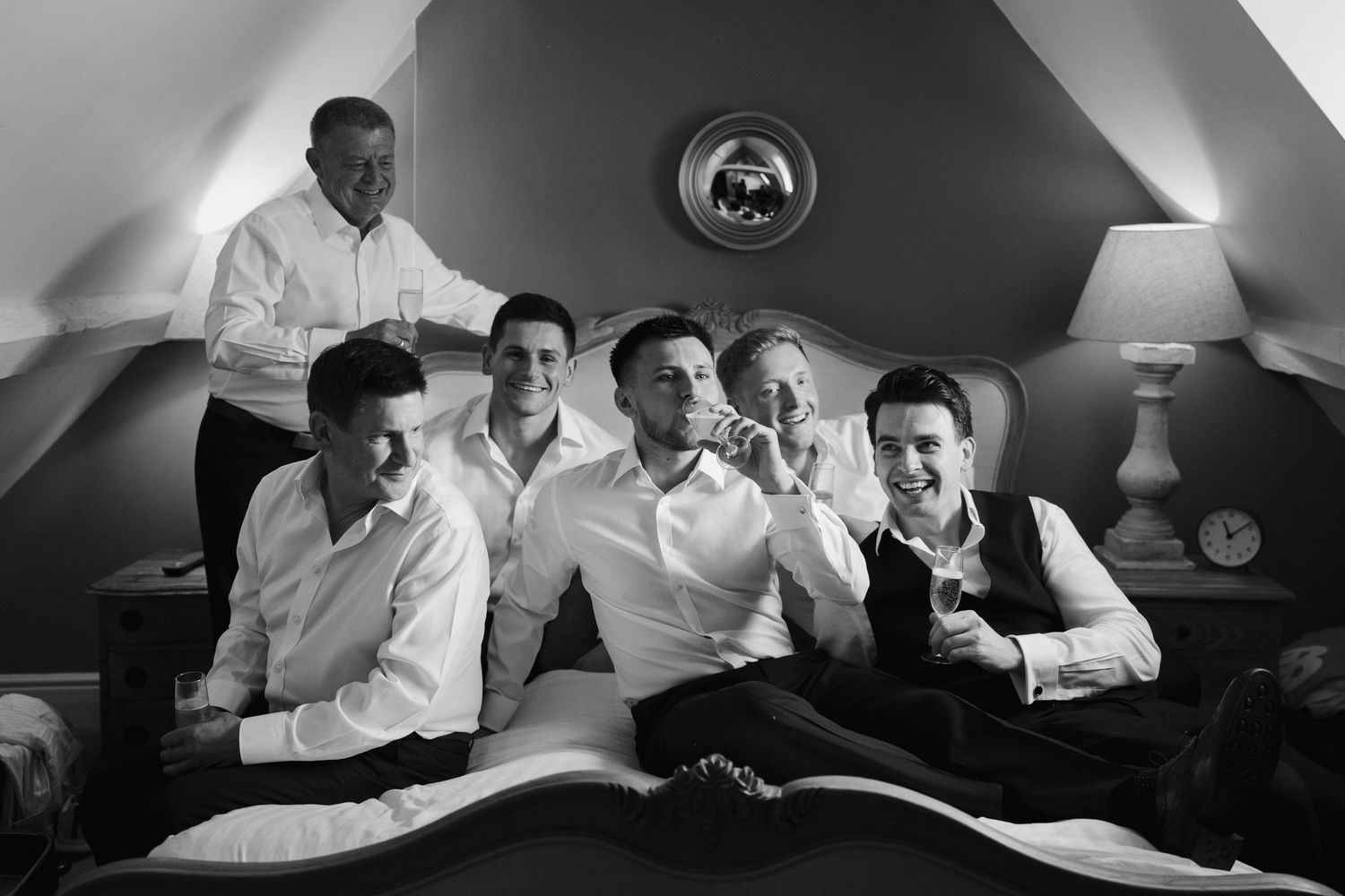 groom and groomsmen celebrating at the new inn cirencester