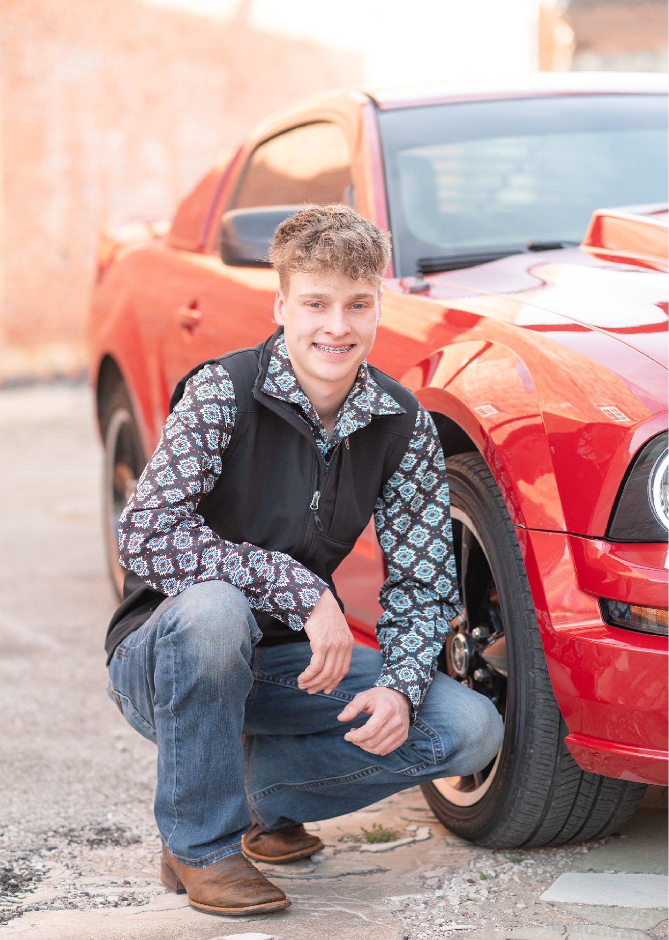 Senior Guy with Red Sports Car in Downtown Bartlesville and Field by Bartlesville Photographer Kristi Bray