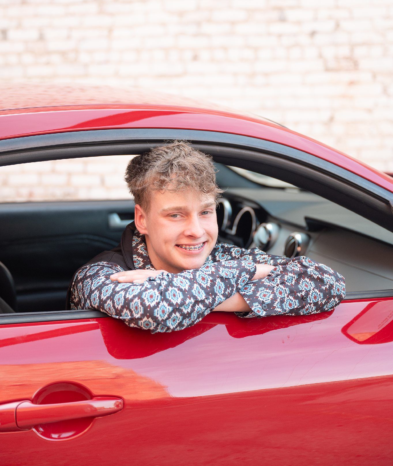 Senior Guy with Red Sports Car in Downtown Bartlesville and Field by Bartlesville Photographer Kristi Bray
