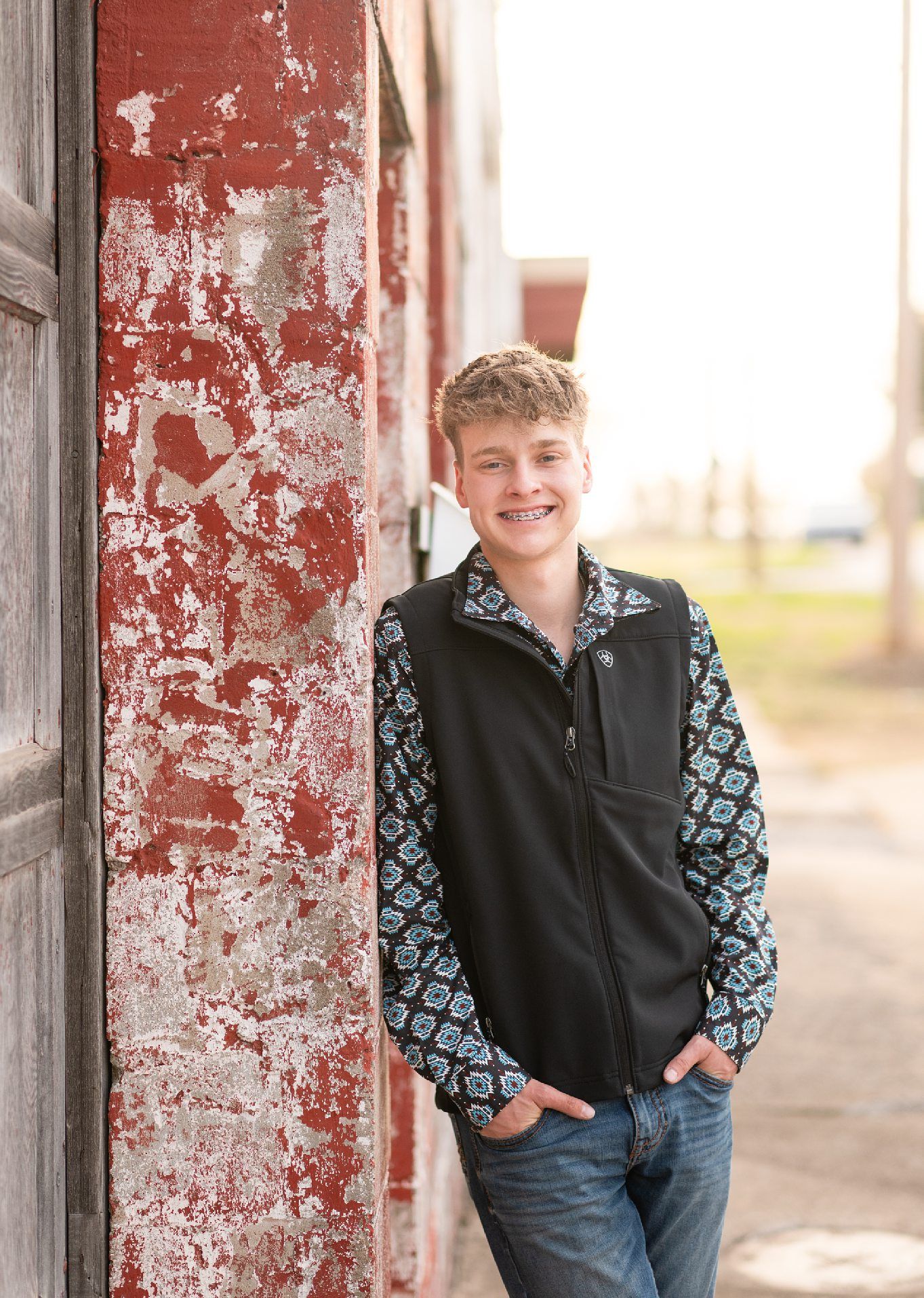 Senior Guy with Red Sports Car in Downtown Bartlesville and Field by Bartlesville Photographer Kristi Bray