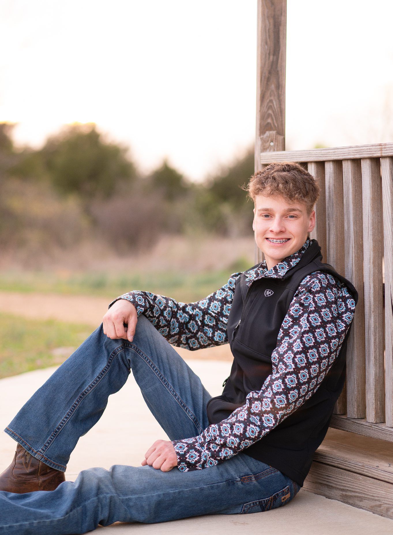 Senior Guy with Red Sports Car in Downtown Bartlesville and Field by Bartlesville Photographer Kristi Bray