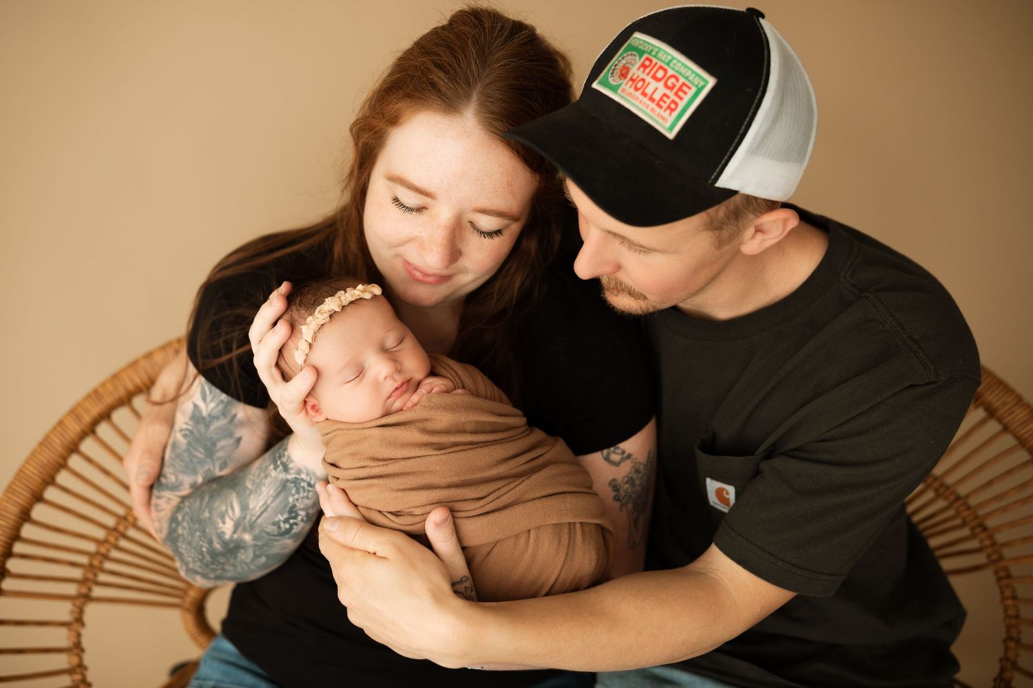 Intimate lifestyle portrait session on neutral backdrop shows gentle family moments.