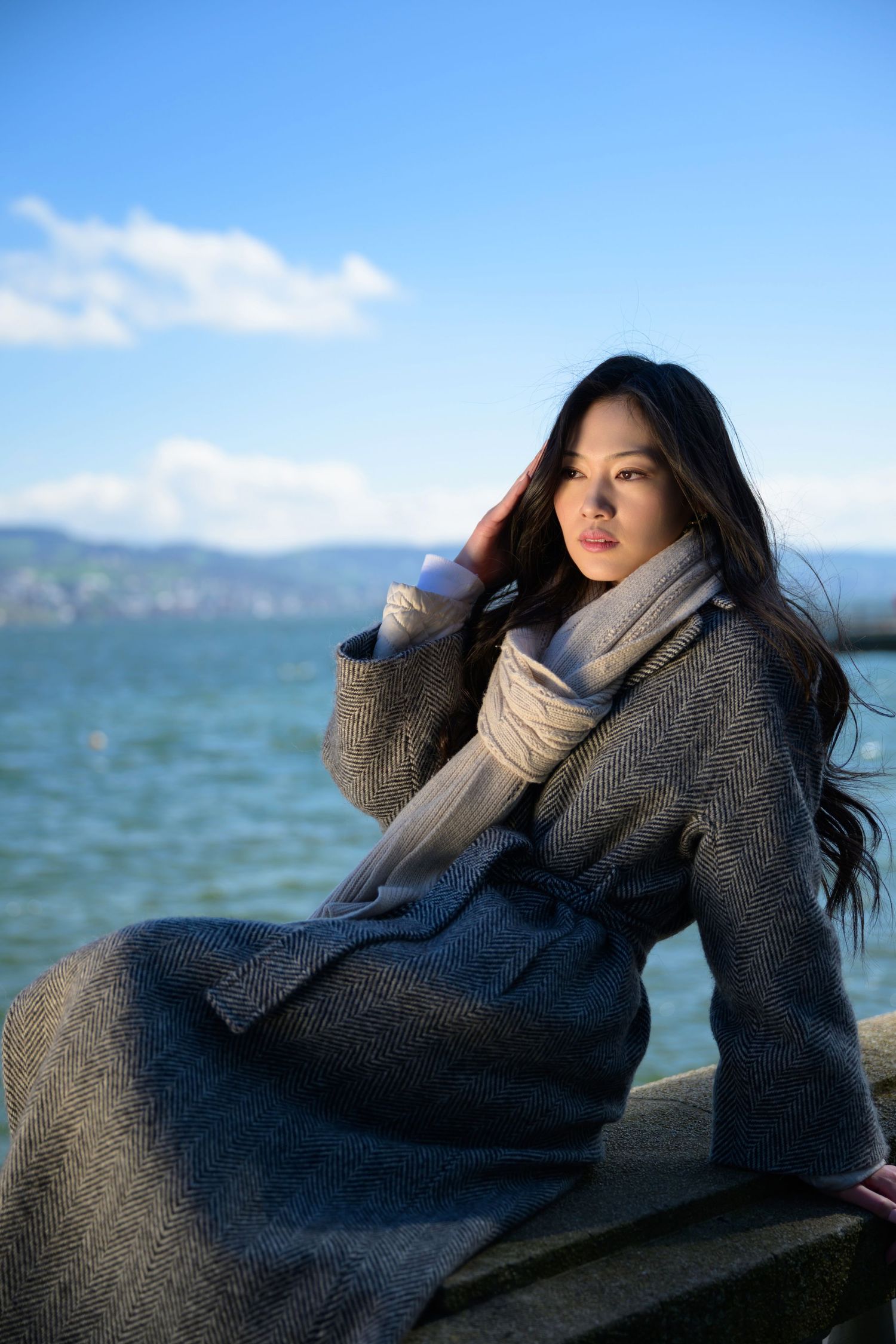 Outdoor fashion shoot in Switzerland with a model in a flowing outfit, styled in natural light. Clean, editorial aesthetic. Next level