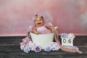 Six images display various composition shots of a newborn baby photo session setup against a pink backdrop and rustic wood.