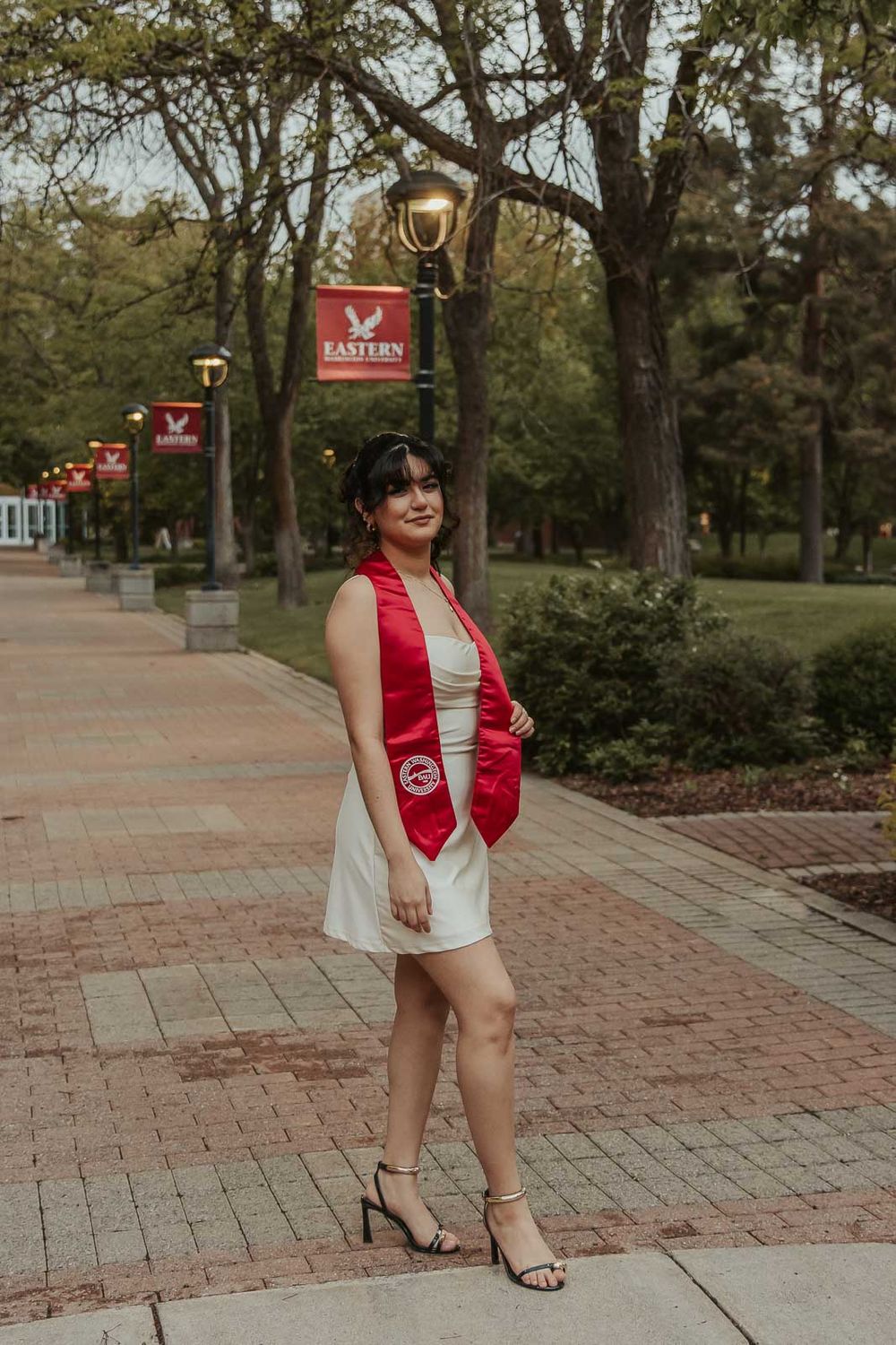 Eastern Washington University senior photos of Laura in cap and gown on the Cheney, WA campus.