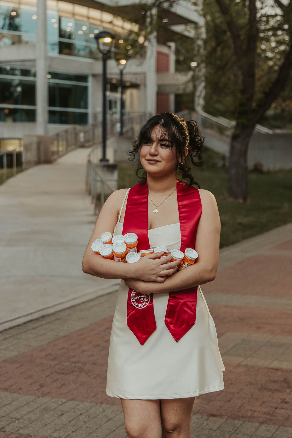 EWU senior holding past prescription bottles to celebrate mental health journey