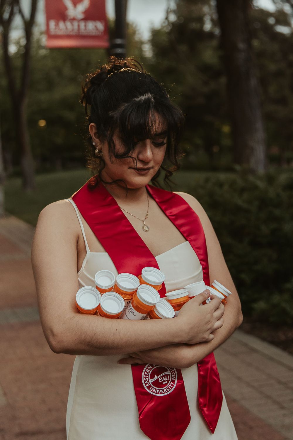 EWU senior holding past prescription bottles to celebrate mental health journey
