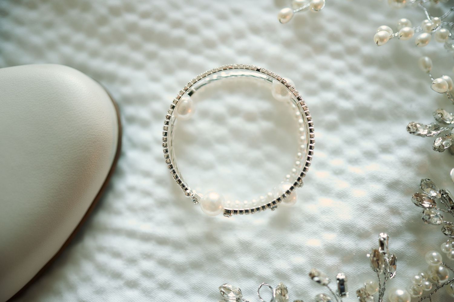 Bride shoe, bracelet and hair decoration close up.