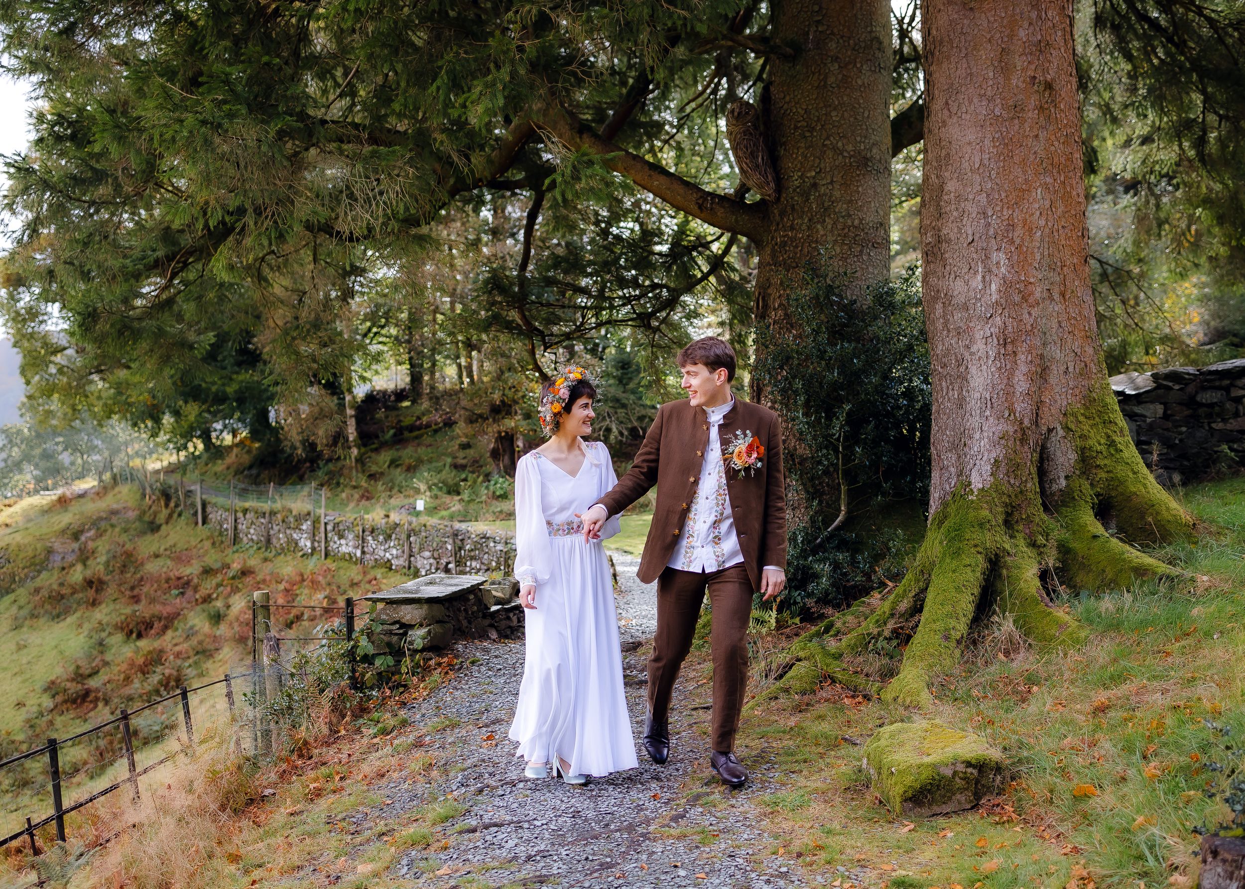 non-traditional wedding photographer in the Lake District - bride and groom walking the grounds