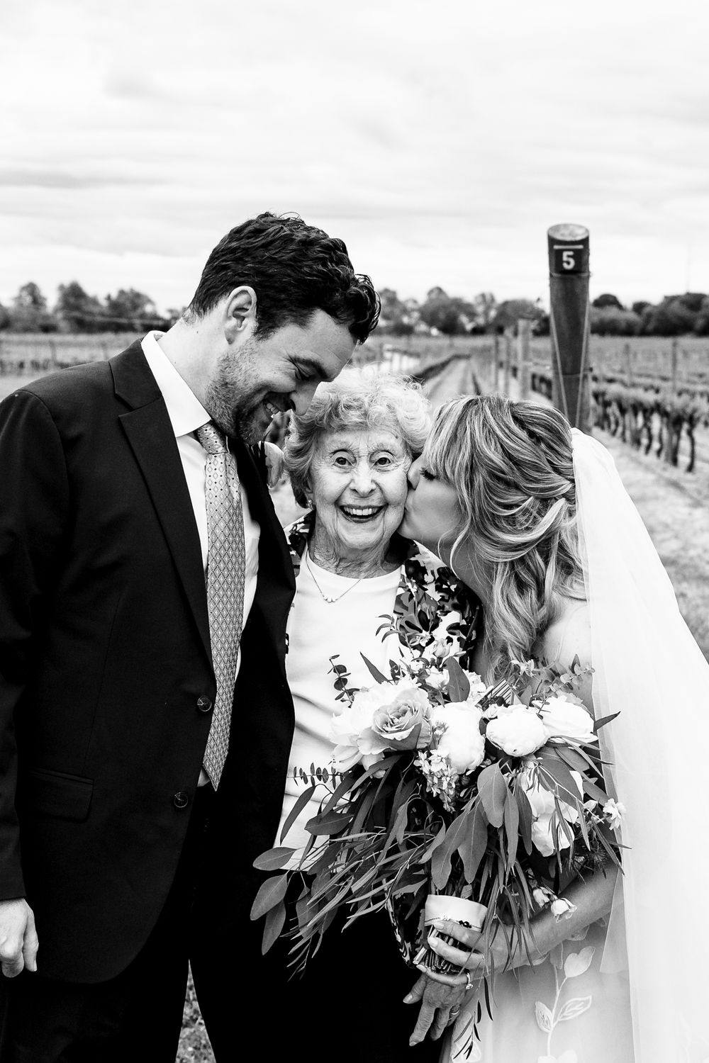 Black and white wedding portraits showing joyful moments of celebration outdoors.
