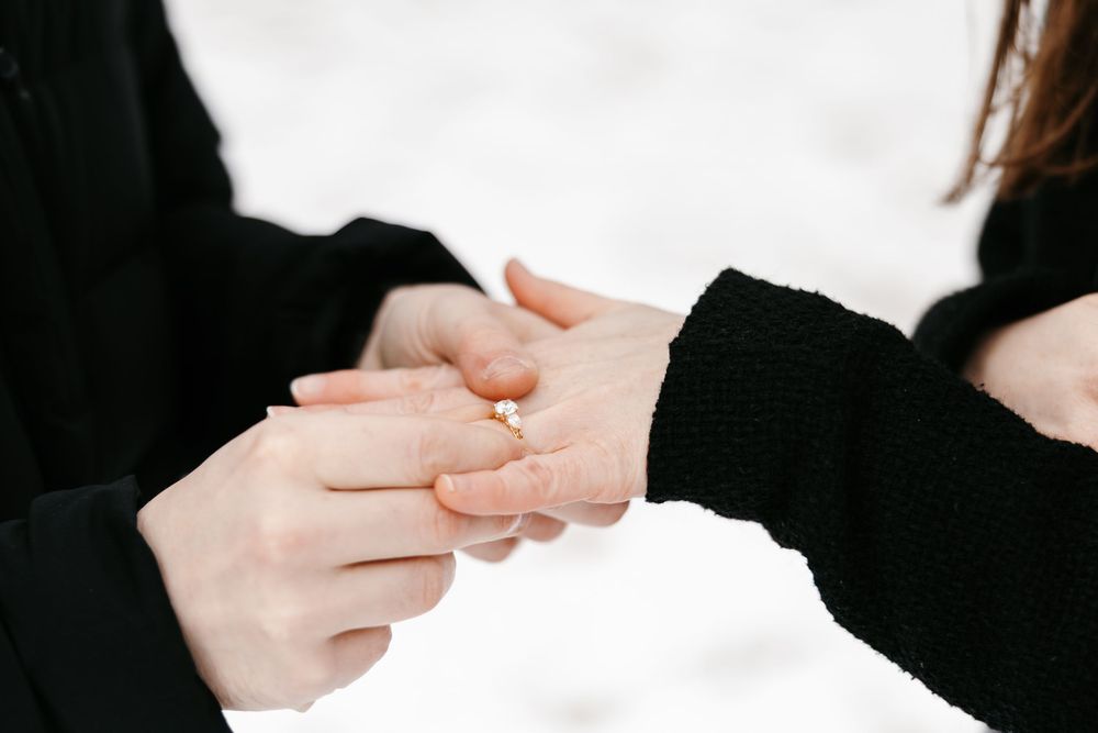 A sequence of hands exchanging business cards against a white background in a professional setting.