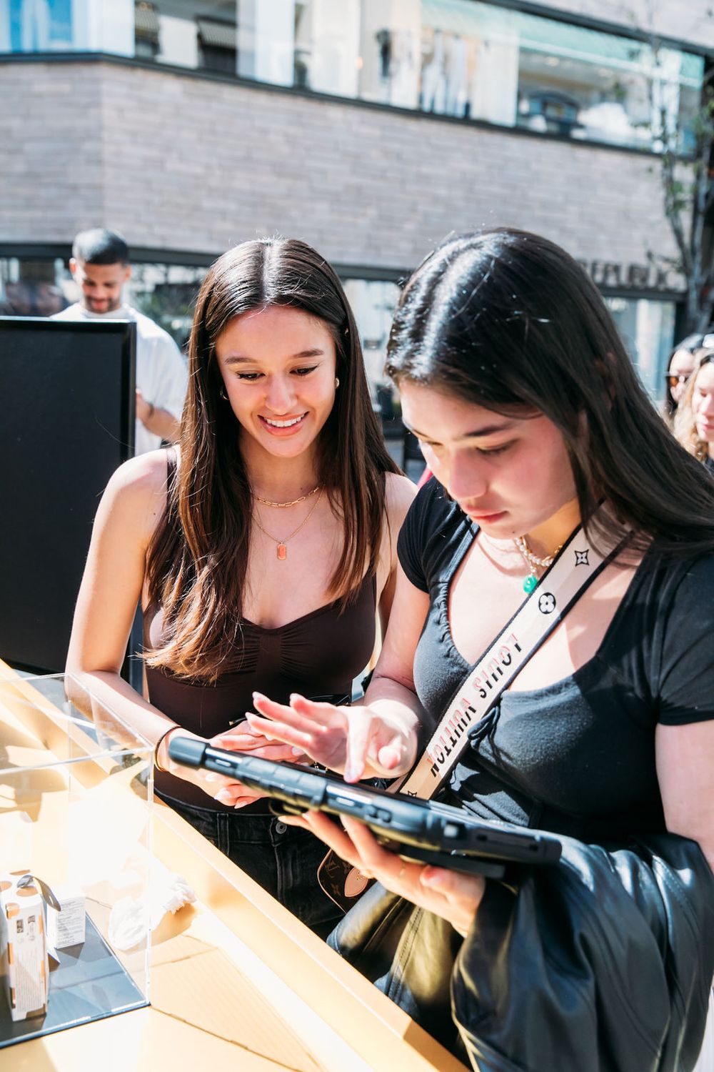 Two friends looking at their phones while dining at a casual restaurant.