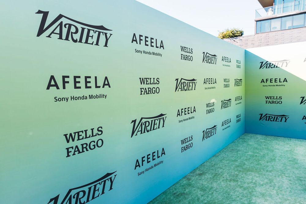 Step and repeat wall with Variety and Wells Fargo logos at a media event creates a turquoise gradient backdrop.
