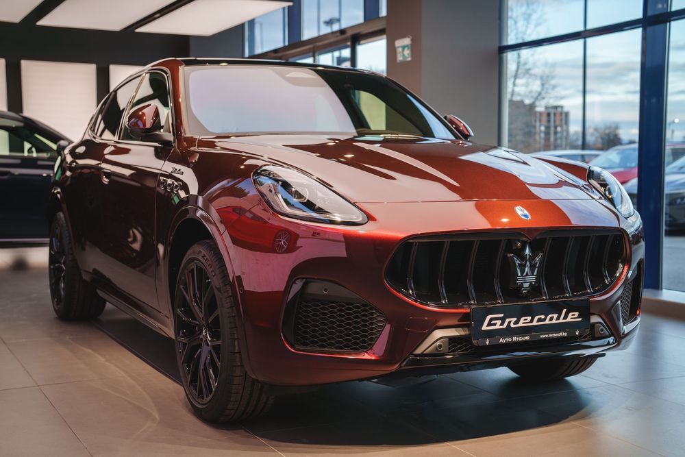 A burgundy Maserati Levante luxury SUV displayed in a modern car dealership showroom.