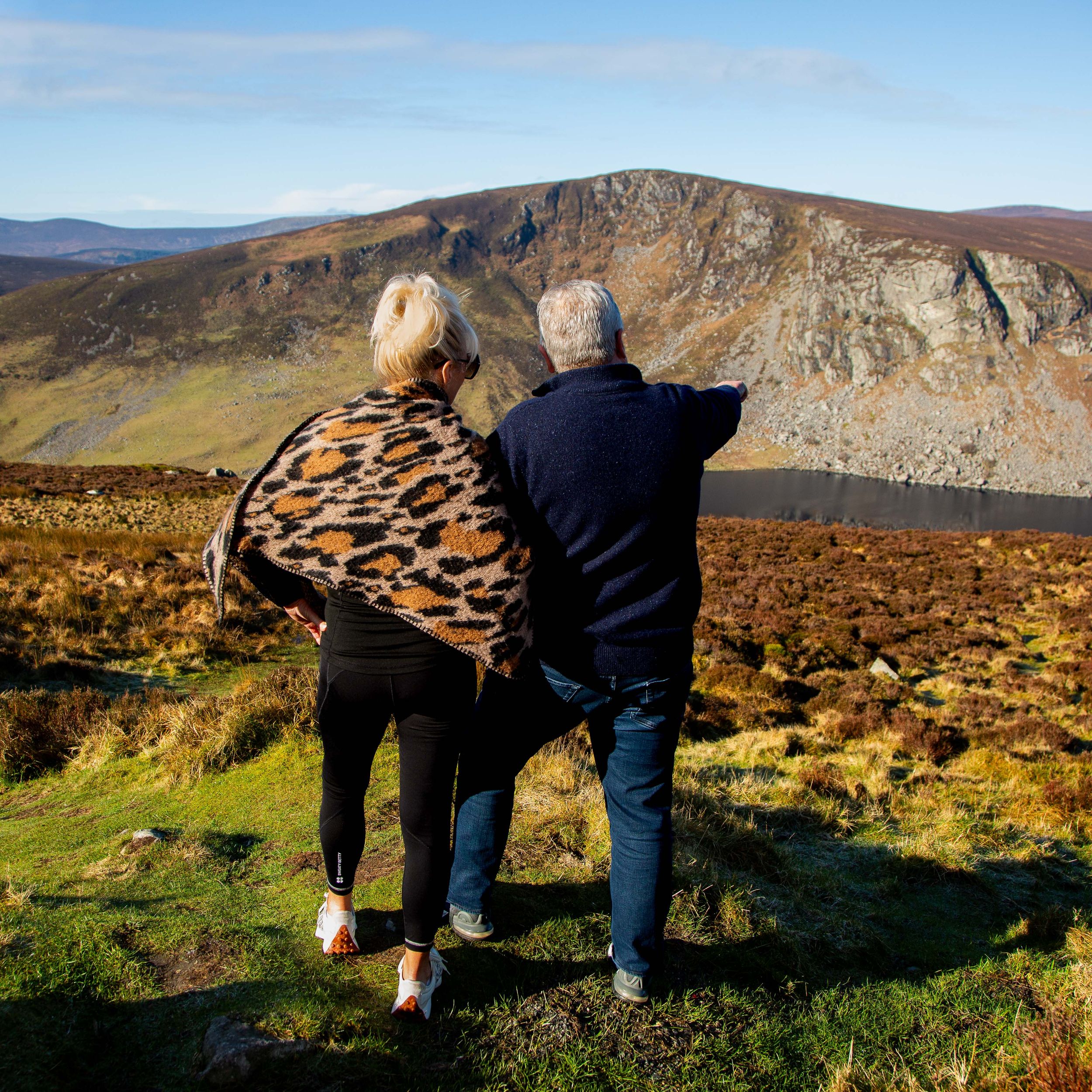 Couple standing together enjoying the wicklow mountains at Lough Tay in County Wicklow