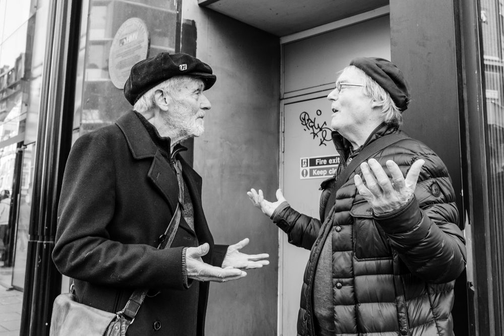 A black and white photo montage shows someone gesturing and speaking through multiple candid frames.