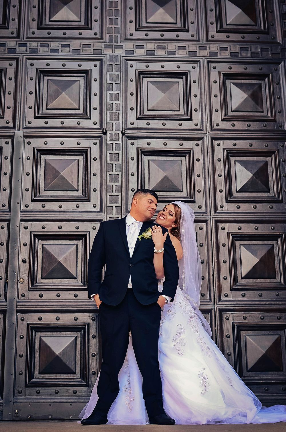 A wedding couple poses against an ornate dark metal door in three artistic compositions.
